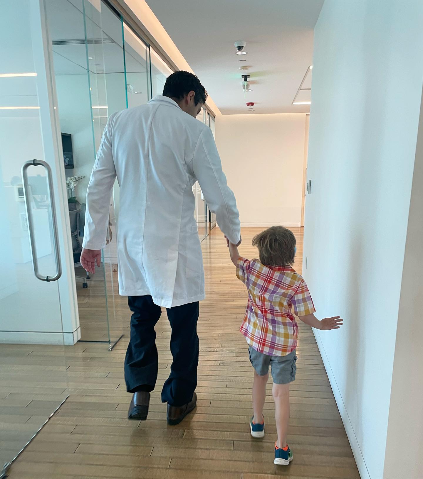 Dr. Tahiri holding a patient's hand