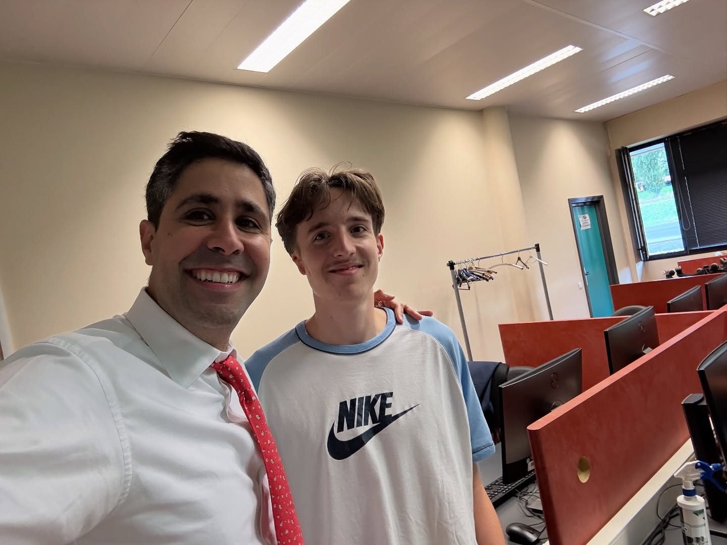 Dr. Tahiri smiling with a young patient in a classroom setting