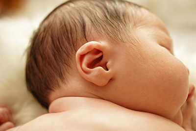 Close-up of a sleeping newborn baby's ear