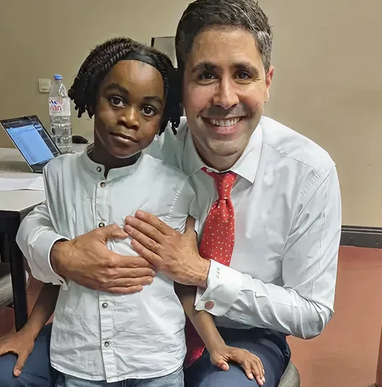 Dr. Tahiri with a young patient